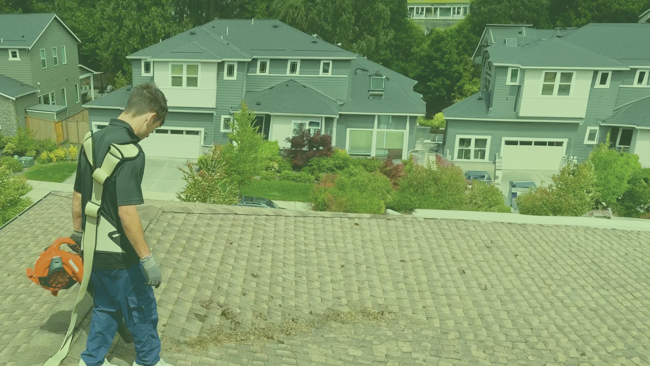 Xzavier's technician cleaning a roof